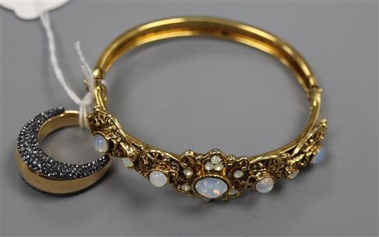 A paste set gilt metal bangle and a similar dress ring.